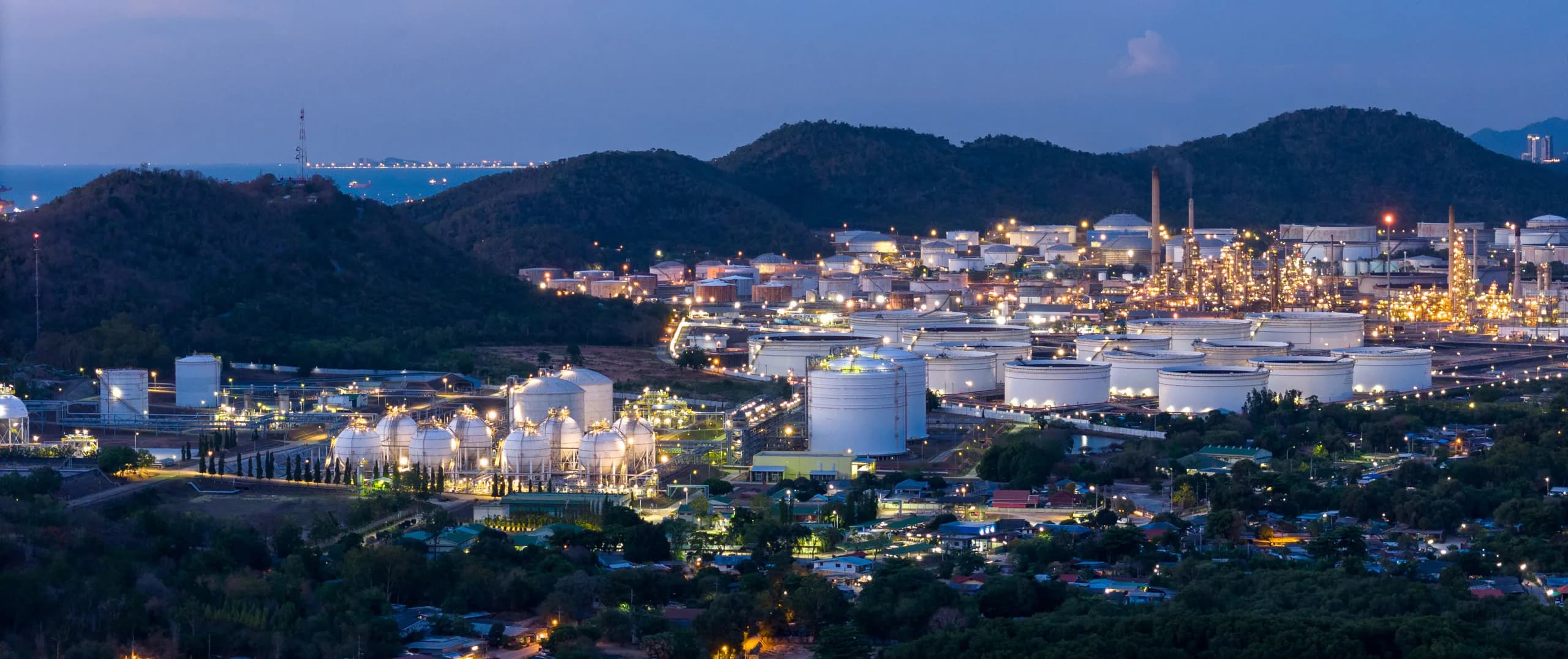 Industrial facility at night representing commercial and industrial power challenges